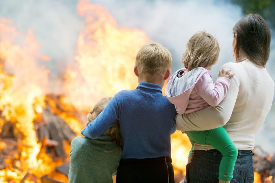 Family watching their house burn.